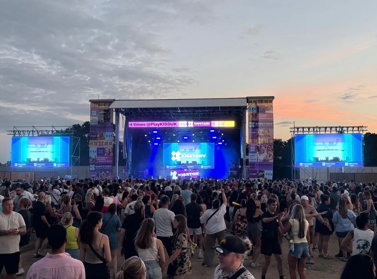 Live music festival crowd and stage with Kisstory branding